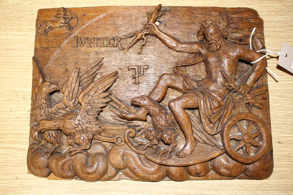 A 19th century Continental relief carved oak plaque depicting Jupiter riding in a chariot pulled by eagles, 25 x 34cm